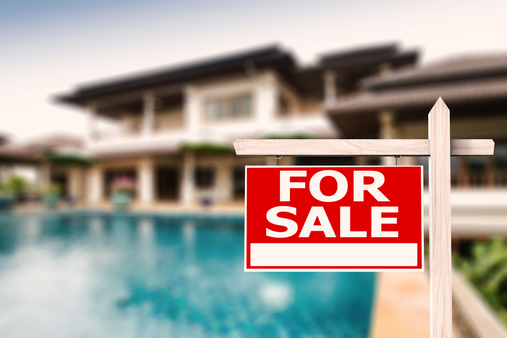 For,Sale,Sign,At,Luxury,House,With,Pool,Background